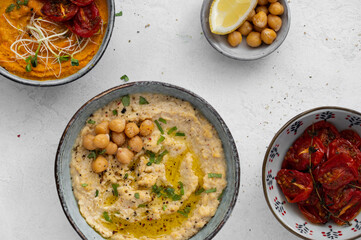 Traditional hummus from chickpea and carrot. Spread. Assorted meze and dips with crispy pita, lemon and olives. Middle eastern cuisine