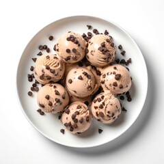 Obraz premium Plate of ice cream scoops with chocolate drops on white background, top view.