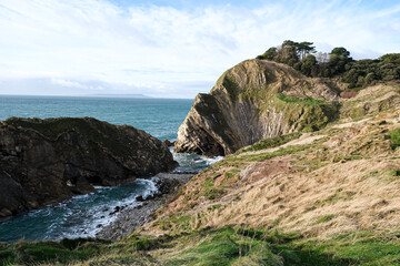 Lulworth Cove cliffs view on a way to Durdle Door. The Jurassic Coast is World Heritage Site on the English Channel coast of southern England. Dorset, UK. Jurassic coast view in Dorset, UK. Stair Hole