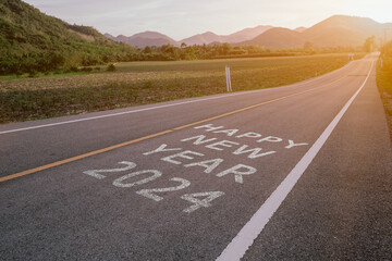 The words Happy New Year 2024 written on an empty road , Concept of New year 2024.