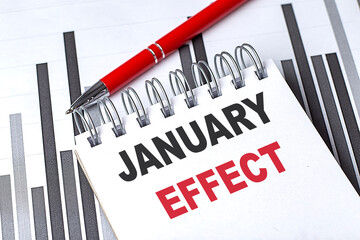 JANUARY EFFECT text written on notebook with pen on chart