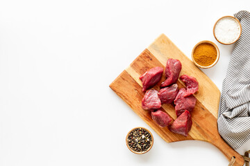 Beef meat on wooden board ready for cooking. Food background