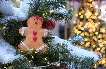 Cute christmas gingerbread man on a snow-covered Christmas tree.