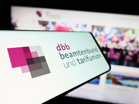 Stuttgart, Germany - 12-14-2023: Mobile phone with logo of trade union center DBB Beamtenbund und Tarifunion in front of website. Focus on center-left of phone display.