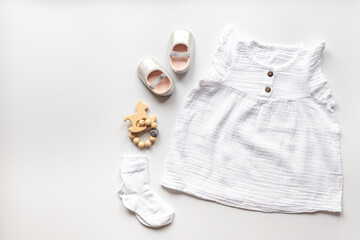 Obraz na płótnie Canvas Fashion trendy look of baby girl with white dress and accessories