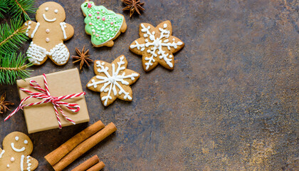 Gift box, gingerbread cookies and spices on rustic background. Christmas card