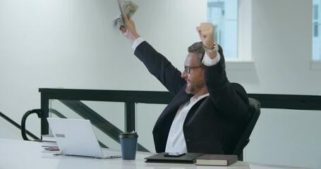 Excited business man counting dollars in office. Rich man in suit with dollars. Business man hold dollars money banknotes. Boss in suit count dollars. Budget, payment, financial planning. Dollar bill.