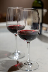 Tasting of red dry Saint-Emilion wine aged in French oak wooden barrels in cellar, Saint-Emilion wine making region, France, Bordeaux