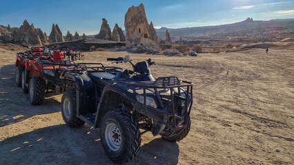 ATVs poised in a picturesque lineup as the sun dips over Red Valley in Cappadocia.