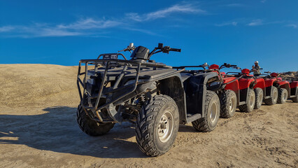 Multiple ATVs aligned, awaiting their next journey amidst the grandeur of Red Valley.