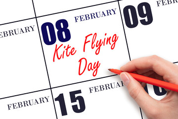 February 8. Hand writing text Kite Flying Day on calendar date. Save the date.