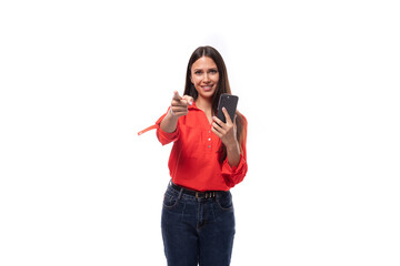 young successful brunette assistant woman dressed in a red blouse uses the phone on a white background with copy space