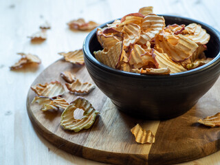 Dried apple slices on the table. Healthy treats. Homemade crispy apple chips