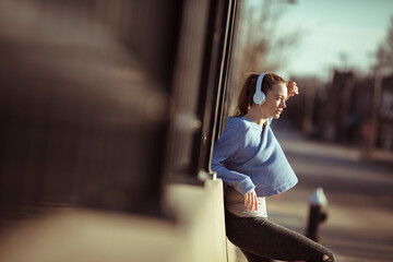 Young Woman Resting with Headphones During Outdoor Exercise