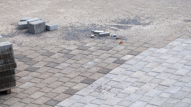 paving bricks, in the photo there is a sidewalk and paving bricks during repair work