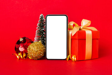 Digital phone mock up with rustic Christmas decorations for app presentation with empty space for you design. Christmas online shopping concept. Tablet with copy space on colored background
