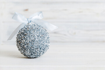 Christmas ball on colored background. decoration bauble with ribbon bow with copy space