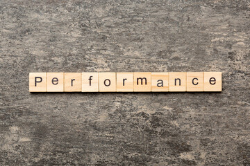 performance word written on wood block. performance text on table, concept