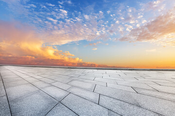 Empty brick floor and sunset clouds background