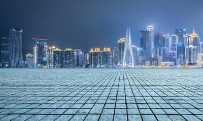 Empty brick road and city buildings skyline night view in Chongqing