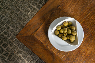 Green olives in a rustic Alentejo restaurant setting.