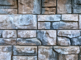 Abstract masonry wall surface of blue textured smooth stones. Design of poster.