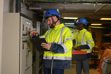 engineering technician Setting up the solar panel inverter in the electrical room Service engineer...