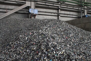 Shredded plastic pieces prepare for recycling. Raw cables material for reproduction. Sorting...