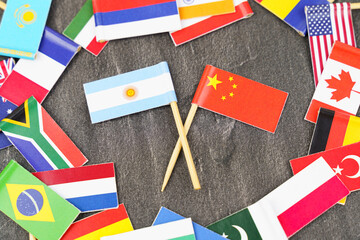 Fototapeta na wymiar The concept is diplomacy. In the middle among the various flags are two flags - China, Argentina
