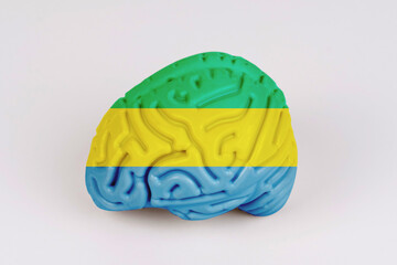 On a white background, a model of the brain with a picture of a flag - Gabon