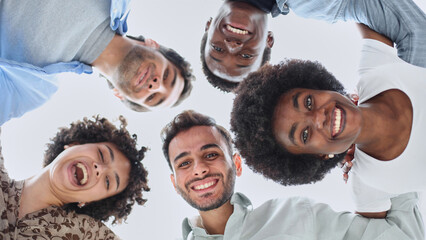 Closeup portrait, bottom view, happy faces of different team employees standing in circle