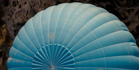 close-up upper view of a blue hot air balloon flying over the countryside , Cappadocia, Turkey