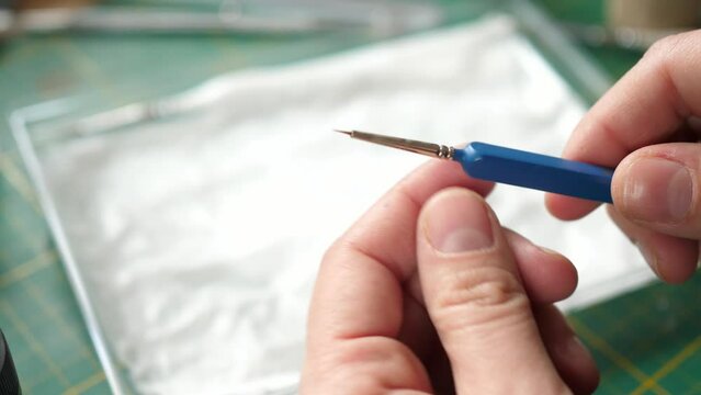 showing small kolinsky fine detail sable brush for painting tabletop minis, miniatures for rpg game