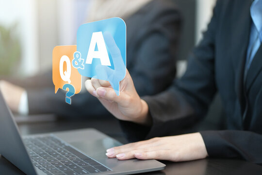 Business Hand Clicking Q&A Or Question And Answer Button. Business Woman Holding Posts In Q&A. Women Answer Customer Questions Online. Online Service Gives Quick Answers. FAQ Concept, Ask Questions,