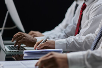 professional businesspeople working together, on research plan in boardroom.