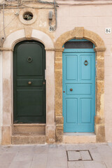 Two doors facade of old town in Polignano a Mare