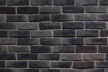 Detail of a section of a grey and black brick wall