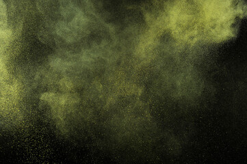 Yellow color texture. Smoke grunge backdrop. Light sky cloud. Gold powder explosion on black...