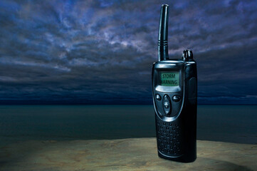 Ocean behind a radio with a storm warning