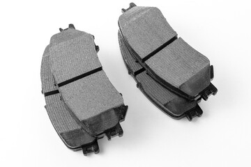 Modern new brake pads for passenger car ventilated disc brakes, brake pads close-up on white...