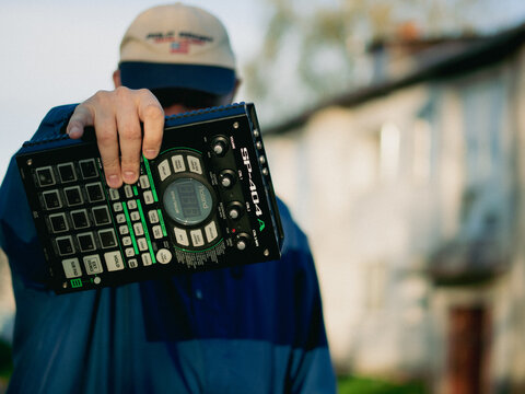 moscow. russia. 08. 06. 2022. Beatmaker on the block with a Roland midi device. DJ plays hip hop music. A beatmaker plays beats on a drum machine. rapper with a beat machine dressed as Ralph Lauren