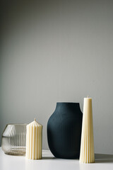 Cozy home Scandy interior decor,modern beige candles,black ceramic vase with dry grass,...