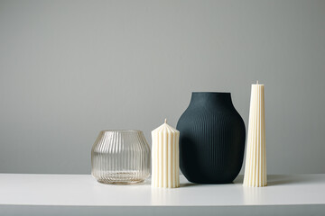 Cozy home Scandy interior decor,modern beige candles,black ceramic vase with dry grass,...