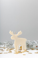 Winter concept with candle reindeer and fir branches. Copy space. White background. cozy winter...