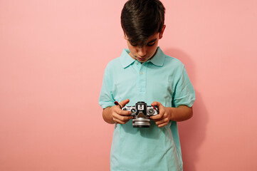 Teen boy with photo camera in the studio.