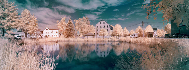 Serene cityscape with peaceful buildings reflecting in calm water.  infrared photography