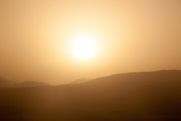 early foggy morning with sunrise in the foggy rocky desert