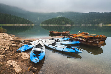 Row Boats and Kayaks on Morning Mountain Lake