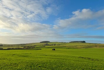 Late day winter landscape, and extensive grassland, with a derelict building, and distant hills above, Draughton, UK