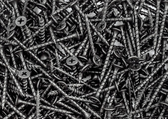 Black self-tapping screws as industrial background. Top view. - 696068548